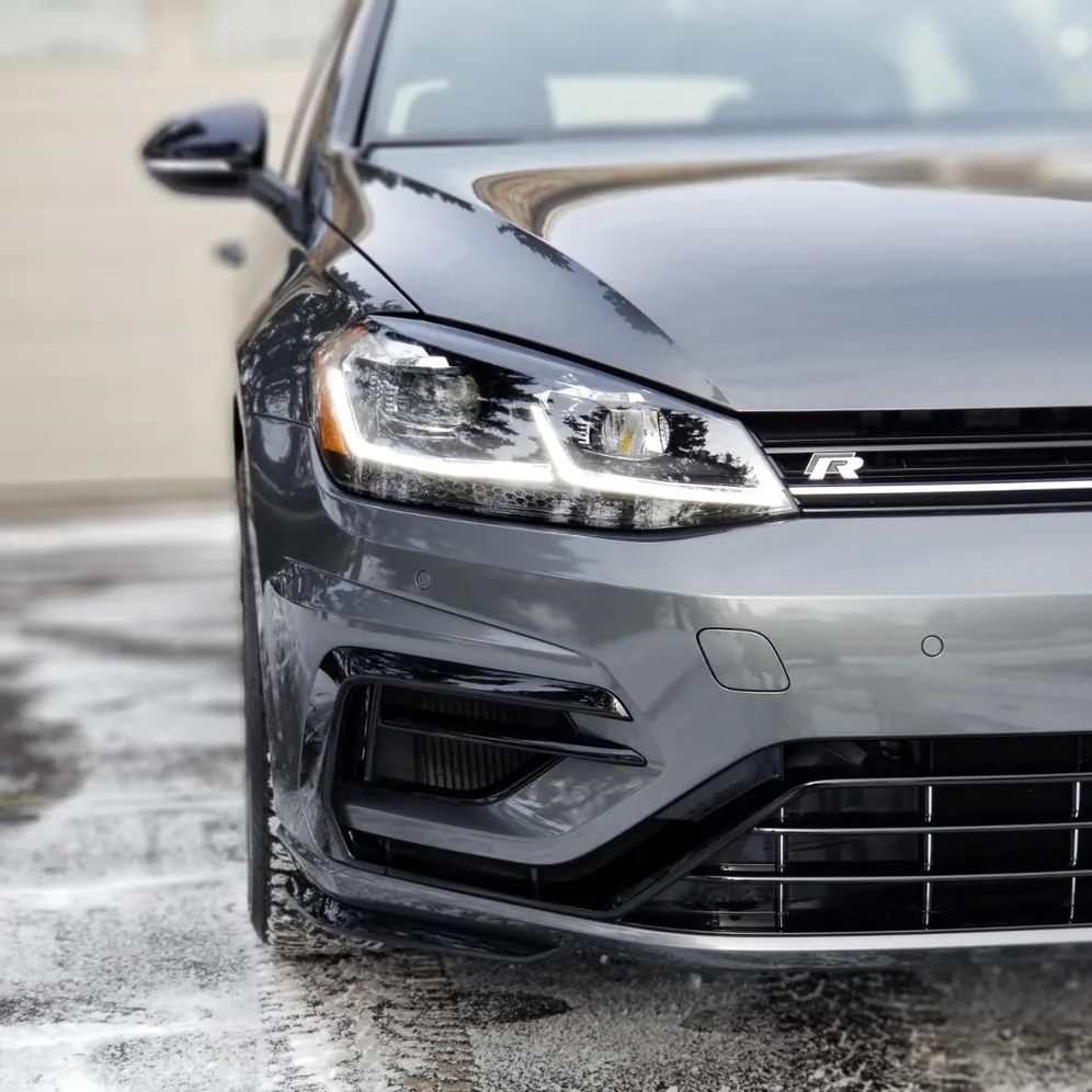 Grey VW Golf R front end and headlights, wet and freshly coated