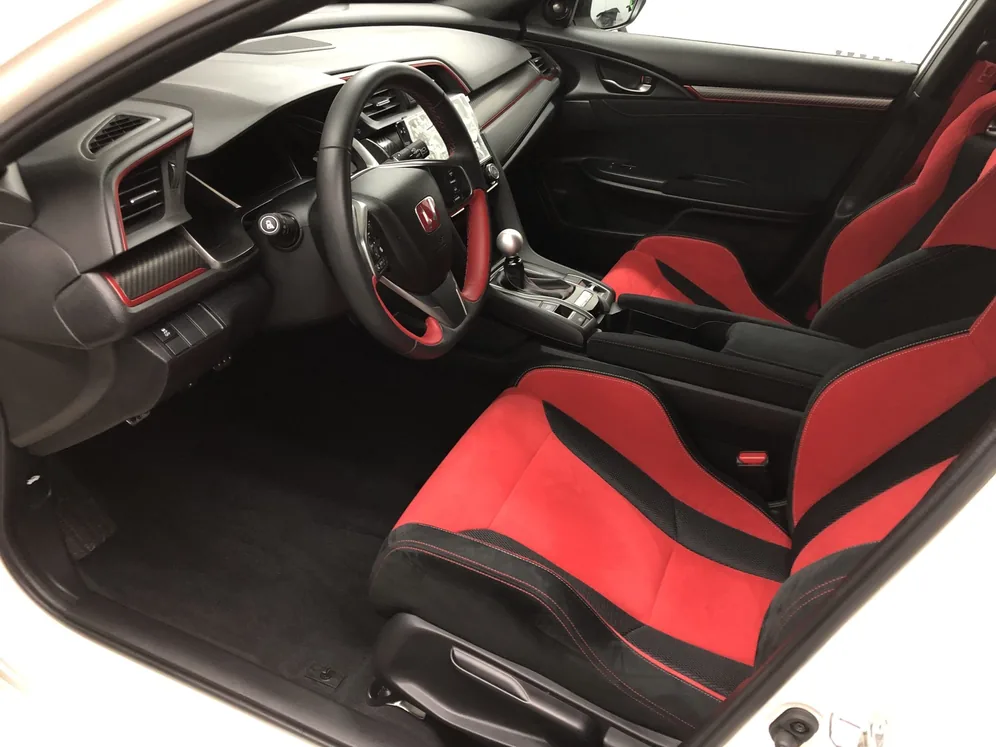 Clean interior with red and black sport seats after a detail