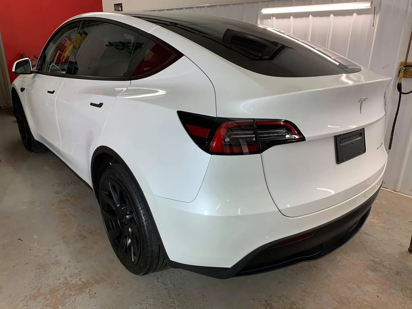 White Tesla Model Y inside the CarShine shop